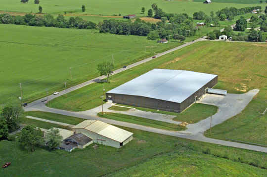 Image of warehouse in green field.